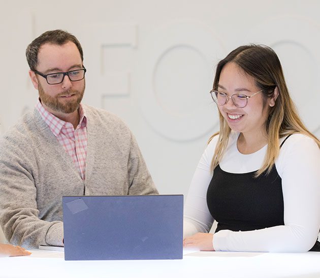 Man and woman looking at laptop screen