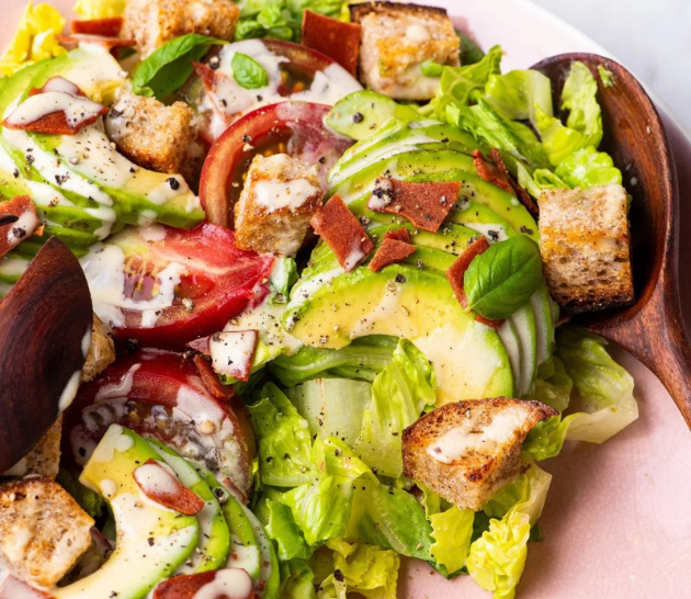 LightLife BLT Salad on a white plate with lettuce, Smart Bacon, avocado, and tomatos